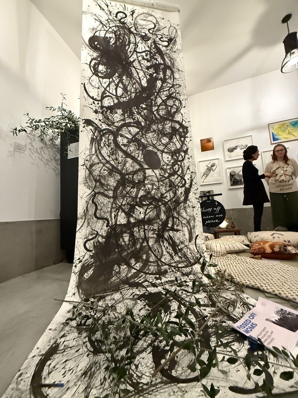 Visitors gathered beside the floor-to-ceiling ink scroll.