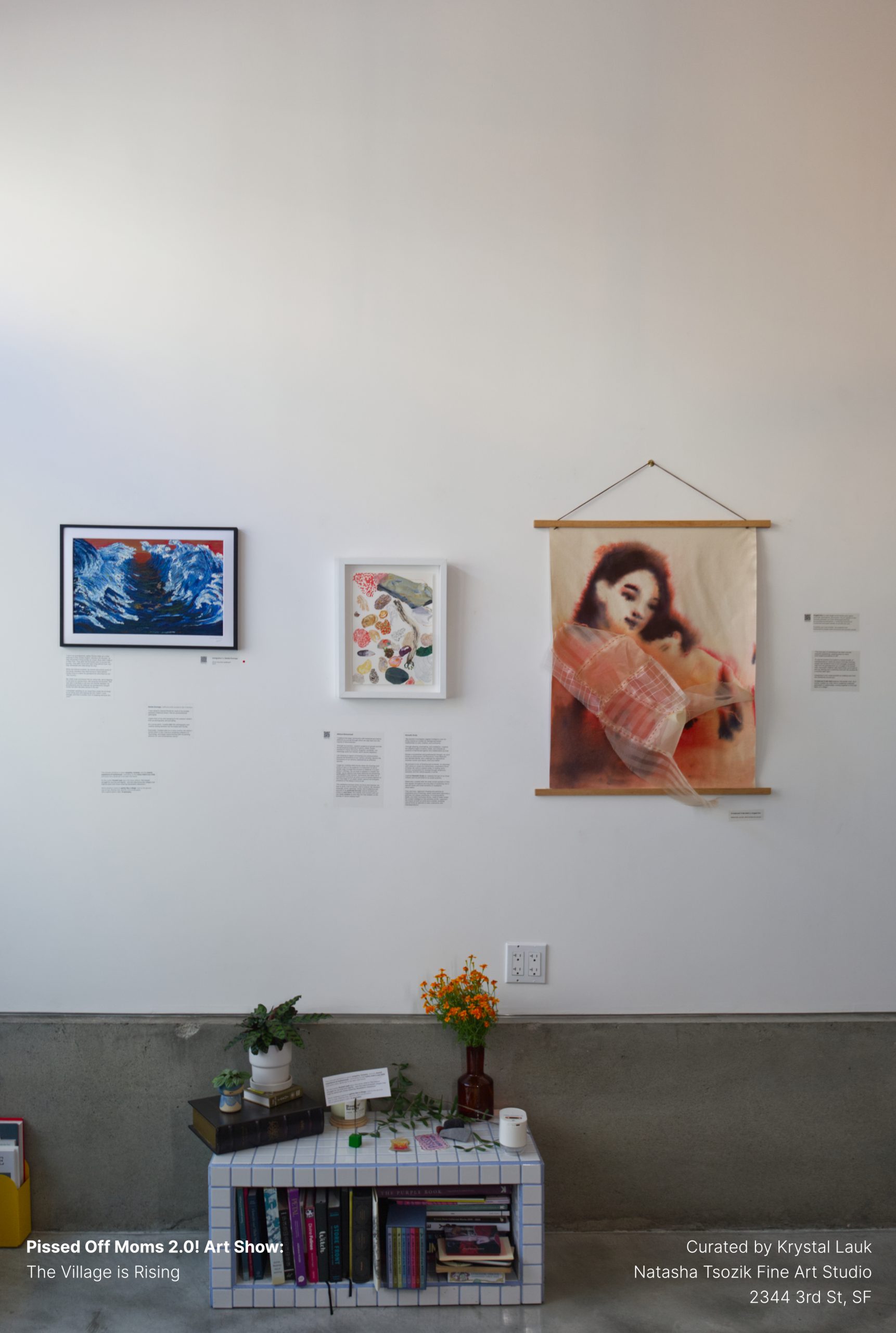 Wall hangings — a cresting wave print and a draped fabric portrait.