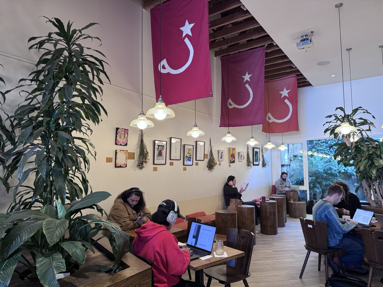 Ritual Coffee Roasters with the show hung along the wall and banners overhead.