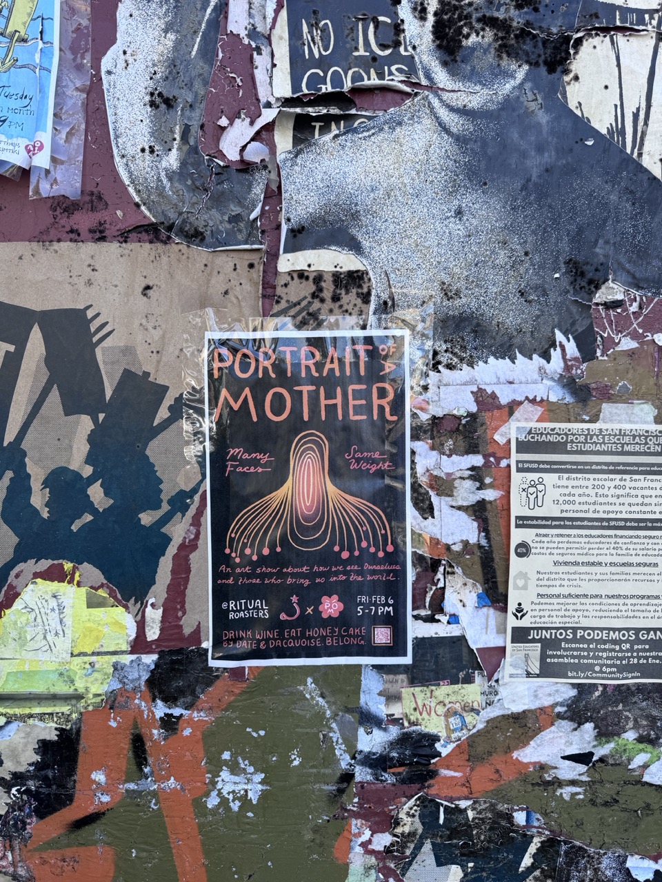 The Portrait of a Mother poster wheatpasted on a layered SF street wall.